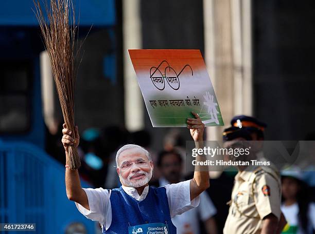 Man wearing India's Prime Minister Narendra Modi mask participate during the 12th edition of the Standard Chartered Mumbai Marathon 2015, on January...