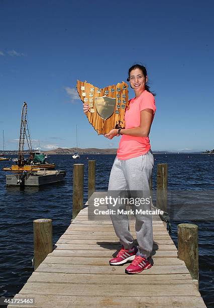 Garbine Muguruza of Spain poses with the winners trophy on a visit to Battery Point after victory in the Women's singles final match against Klara...