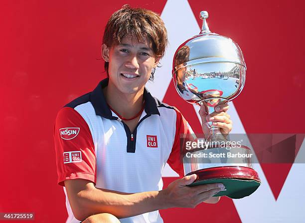 Kei Nishikori of Japan poses with the Kooyong Classic trophy after winning his match against Tomas Berdych of the Czech Republic in the final during...