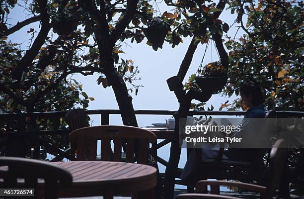 Guest relaxes in the Tree Top Restaurant at Ananda - an Ayurvedic destination spa above Rishikesh in the Himalayas. Ayurveda is a 5000 year old...