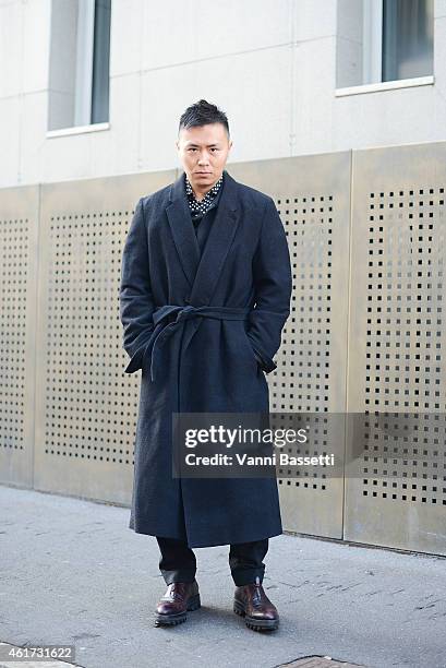 Wei Wang poses wearing a Damir Doma coat and Prada shoes during day 2 of Milan Menswear Fashion Week Fall/Winter 2015/2016 on January 18, 2015 in...