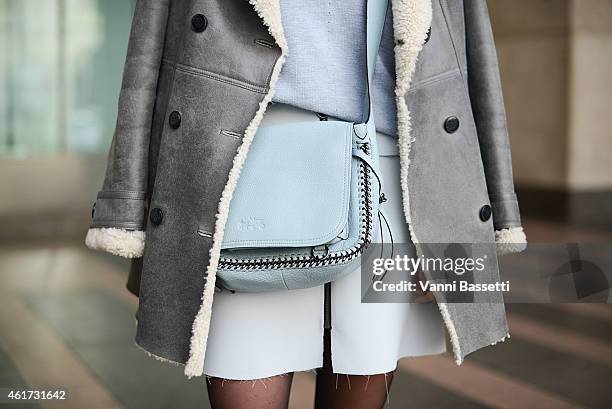Lisa Dengler poses wearing a Tommy Hilfiger coat, Reiss sweater and Coach bag during day 2 of Milan Menswear Fashion Week Fall/Winter 2015/2016 on...