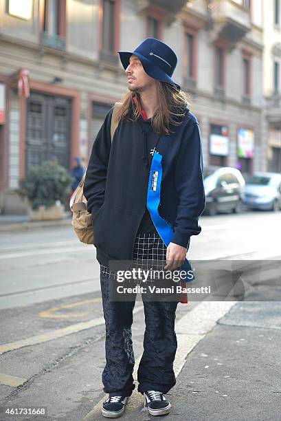 Isaac Larose poses wearing a Stussy X Kiko coat, Dries Van Noten pants, Vans shoes and Larose Paris hat during day 2 of Milan Menswear Fashion Week...