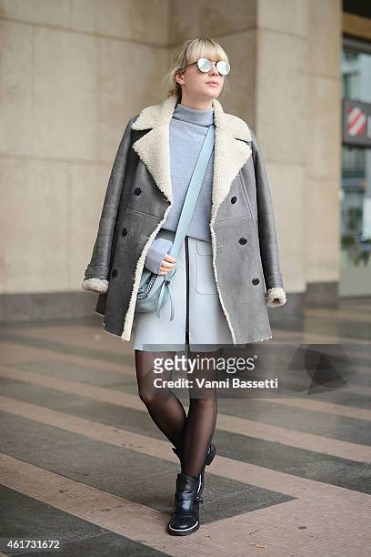 Lisa Dengler poses wearing a Tommy Hilfiger coat, Reiss sweater, Coach bag and Maje shoes during day 2 of Milan Menswear Fashion Week Fall/Winter...