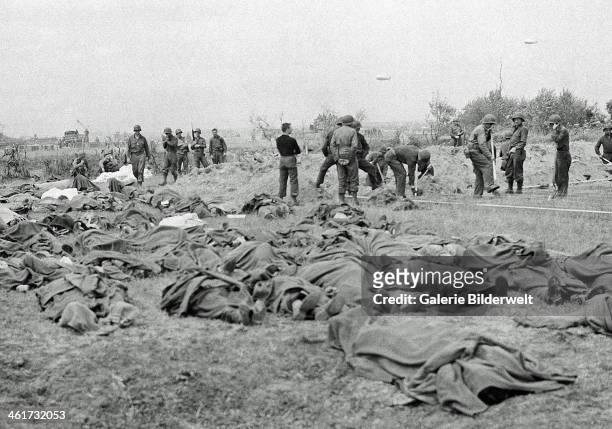 American dead lie in a French field, a short distance from the allied beachhead. 20th June 1944. Normandy, France.