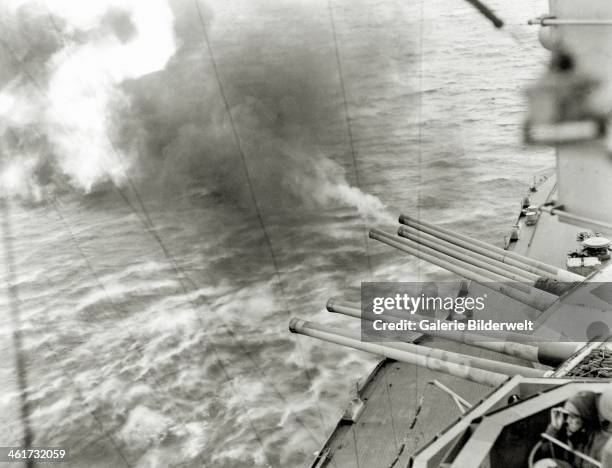 Guns of the battleship USS Nevada are in action on the morning of June 6. 6th June 1944. They are firing on Azeville battery north of Utah Beach....