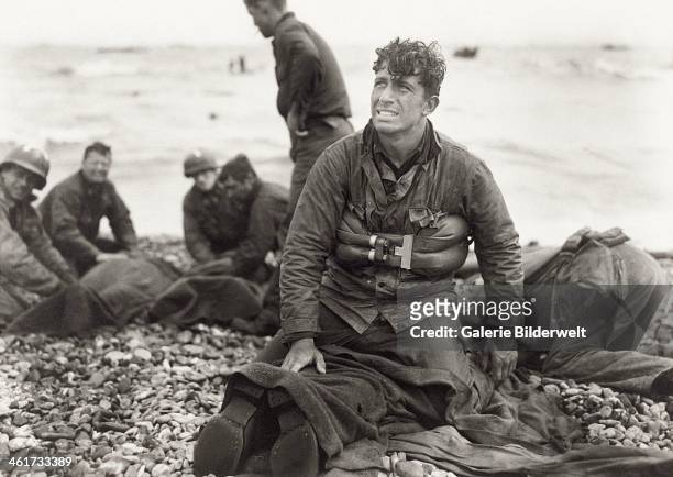 Second Lieutenant Walter Sidlowski of 348th Engineer C Battalion, 5th Engineer Special Brigade, on Omaha Beach, Normandy, after helping to rescue a...