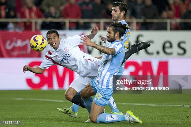 Sevilla's Colombian forward Carlos Bacca vies with Malaga's Argentinian defender Marcos Alberto Angeleri and defender Miguel Torres during the...