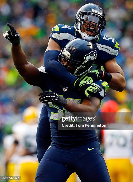 Cliff Avril and Bobby Wagner of the Seattle Seahawks react after making a sack during the third quarter of the 2015 NFC Championship game against the...