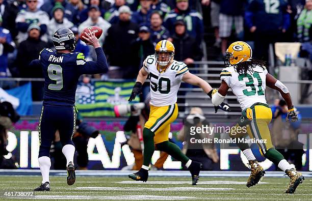 Holder Jon Ryan of the Seattle Seahawks throws a 19 yard touchdown pass to Garry Gilliam in the second half against the Green Bay Packers during the...