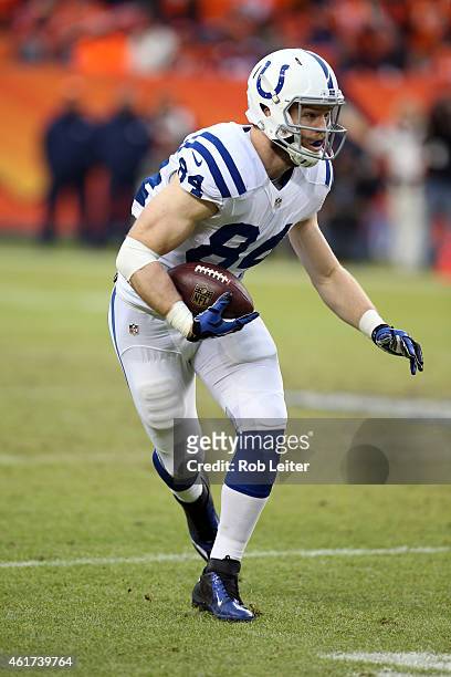 Jack Doyle of the Indianapolis Colts runs after the catch during the game against the Denver Broncos during the 2015 AFC Divisional Playoff game at...