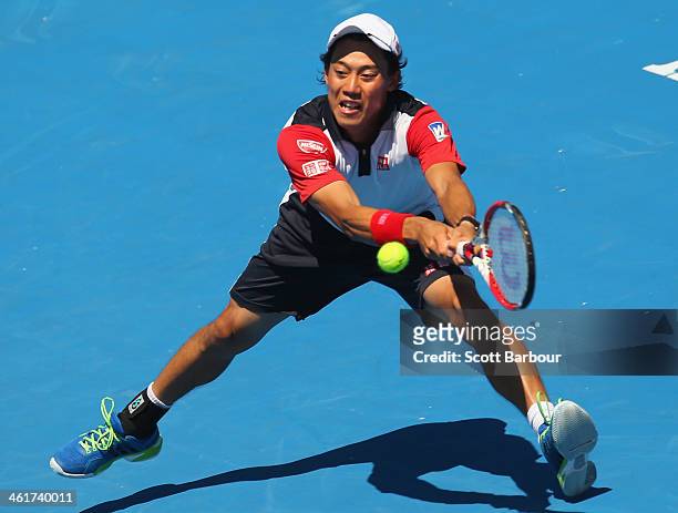 Kei Nishikori of Japan plays a backhand during his match against Tomas Berdych of the Czech Republic during day four of the AAMI Classic at Kooyong...