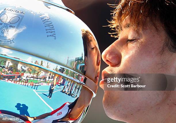 Kei Nishikori of Japan kisses the Kooyong Classic trophy after winning his match against Tomas Berdych of the Czech Republic in the final during day...