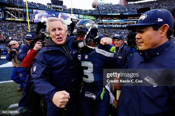 Head coach Pete Carroll and Russell Wilson of the Seattle Seahawks celebrate after the Seahawks 28-22 victory in overtime against the Green Bay...