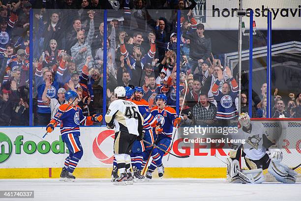 Taylor Hall of the Edmonton Oilers celebrates scoring his team's second goal against the Pittsburgh Penguins along with his teammates Andrew Ference...