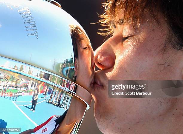 Kei Nishikori of Japan kisses the Kooyong Classic trophy after winning his match against Tomas Berdych of the Czech Republic in the final during day...