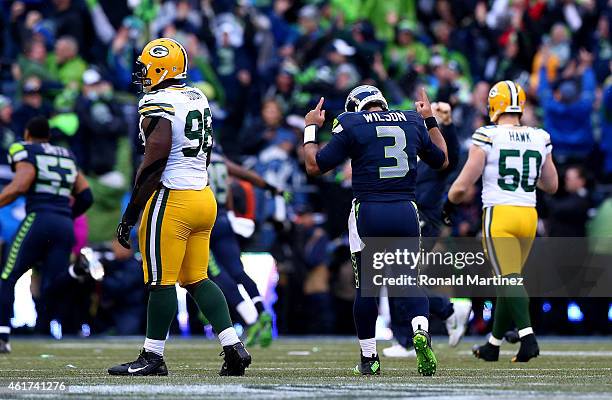 Quarterback Russell Wilson of the Seattle Seahawks celebrates after throwing the game winning touchdown pass to Jermaine Kearse in overtime to defeat...