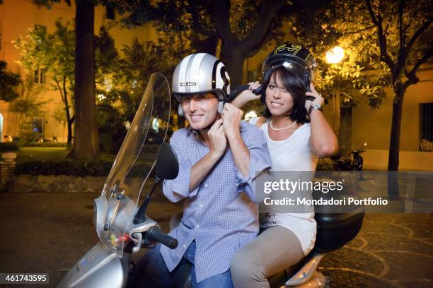 The Italian politician Nunzia De Girolamo and her boyfriend, the italian politician Marco Bocca, on a scooter. Rome, Italy, april, 2011