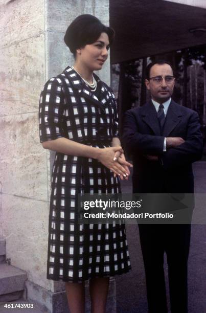 Empress of Iran Farah Pahlavi with a man in the garden of Echtesassi Palace. Farah Pahlavi is the third wife of the Shah of Iran Mohammad Reza...