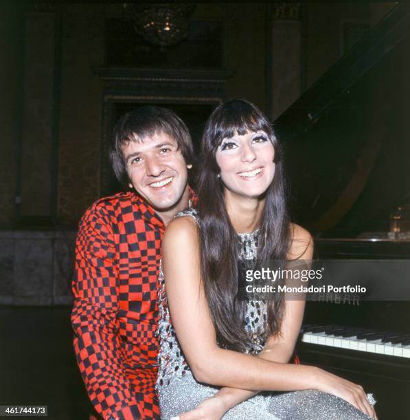 American singer Salvatore Philip Bono, known as Sonny, poses smiling with the singer Cherilyn Sarkisian LaPierre, known as Cher; Sonny wears a...