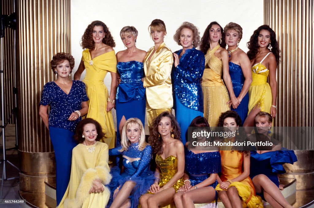 Group shot of the RAI and Fininvest announcers, wearing yellow and blue long dresses