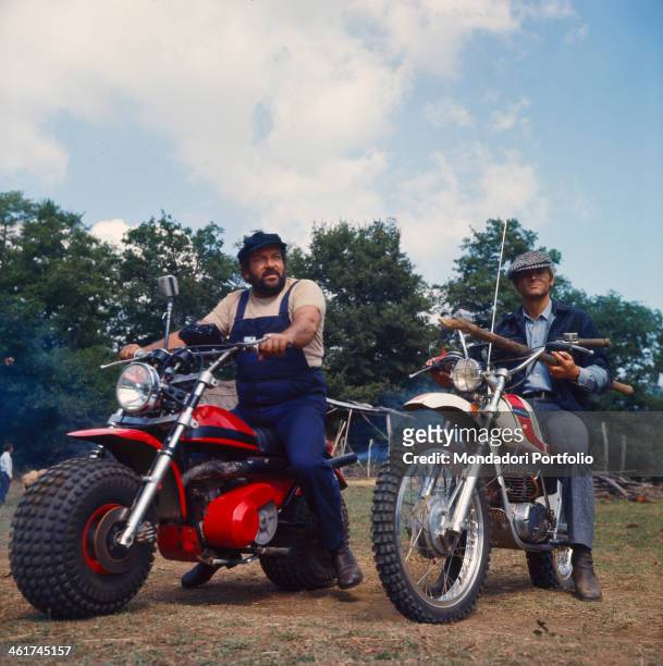 Italian actor and scenarist Bud Spencer and Italian actor, director and scenarist Terence Hill riding two motocross in the film ...altrimenti ci...