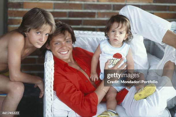 Mexican singer Luis Miguel posing smiling with his brothers Alejandro and Sergio. Italy, 1985