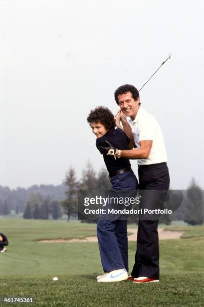 Italian singer-songwriter Memo Remigi and his son Stefano playing golf. 1981