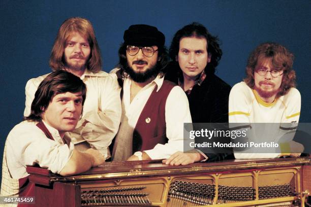 Italian band Nomadi leaning on a piano. The band is composed by Italian singer Augusto Daolio, Italian keyboard player Beppe Carletti , , Italian...