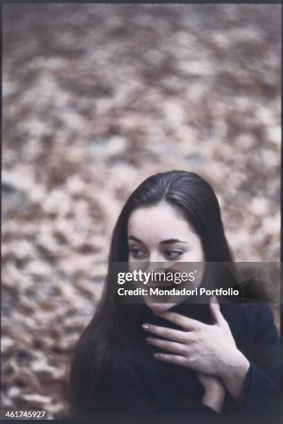 Italian ballet dancer Oriella Dorella posing smiling in a park in Milan in autumn. Milan, 1967