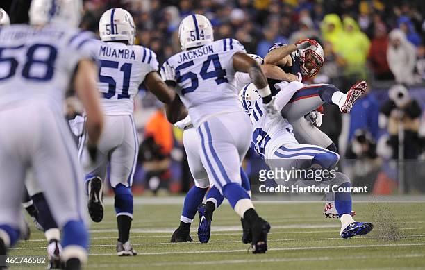 New England Patriots wide receiver Julian Edelman is brought down by Indianapolis Colts free safety Colt Anderson and Indianapolis Colts long snapper...