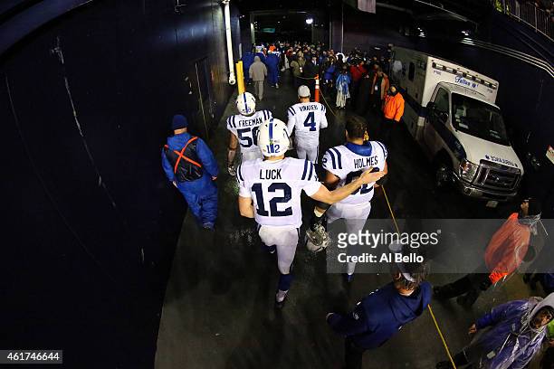 Andrew Luck and Khaled Holmes of the Indianapolis Colts walk off the field after being defeated by the New England Patriots in the 2015 AFC...