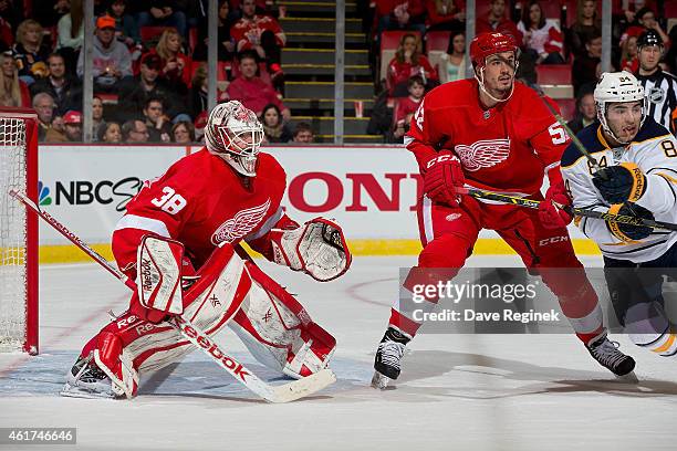 Tom McCollum of the Detroit Red Wings squares up to the play as teammate Jonathan Ericsson battles for position in front of the net with Phil Varone...