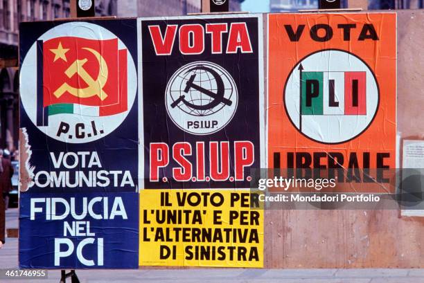 The election posters of Italian Communist Party , Italian Socialist Party of Proletarian Unity and Italian Liberal Party stuck up on the walls...