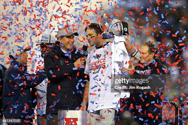 Tom Brady of the New England Patriots holds up the Lamar Hunt Trophy after defeating the Indianapolis Colts in the 2015 AFC Championship Game at...