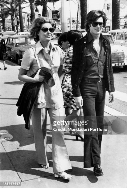 Swedish actress Ingrid Bergman and her son Roberto Rossellini jr walking in a street of Cannes. Cannes, 1970s