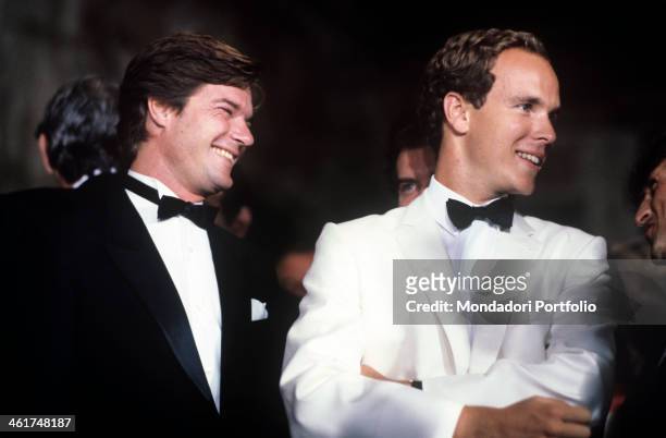 Roberto Rossellini and Prince Albert of Monaco, in smoking, are smiling and joking during the charity organized within the Venice Film Festival to...