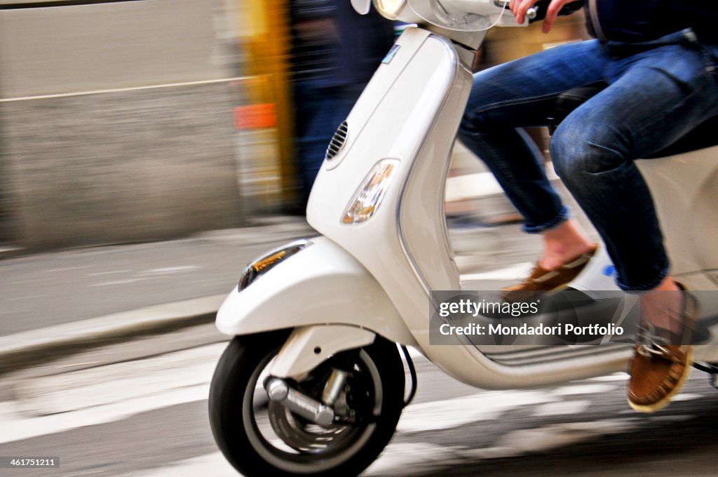 A man driving a scooter in Milan