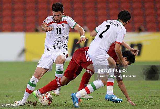 Alireza Jahanbakhsh of Iran tackles Walid Abbas of the United Arab Emirates during the 2015 Asian Cup match between IR Iran and the UAE at Suncorp...