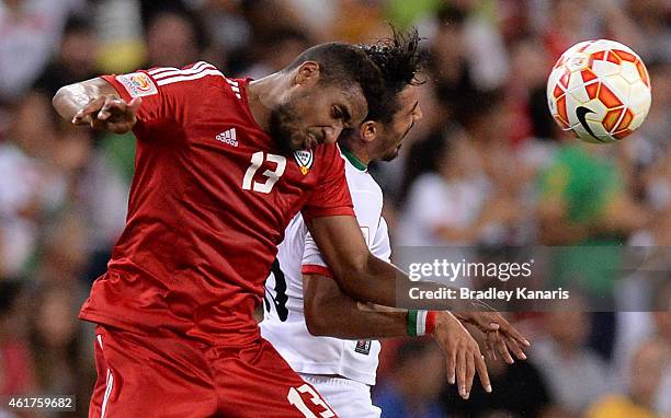 Khamis Esmaeel of the United Arab Emirates and Reza Ghoochannejhad of Iran compete for the ball during the 2015 Asian Cup match between IR Iran and...