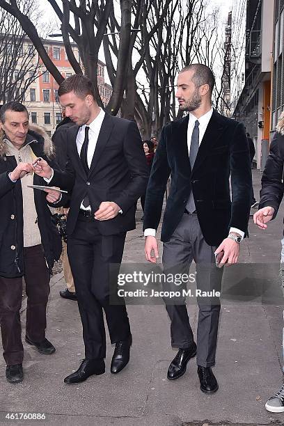 Lukas Podolski and Alessandro Pera are seen leaving the the Emporio Armani Show as a part of Milan Menswear Fashion Week Fall Winter 2015/2016 on...