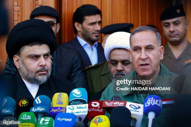 Iraqi Shiite cleric Moqtada al-Sadr and Iraqi Defence Minister Khaled al-Obeidi hold a press conference following a meeting on January 19, 2015 in...