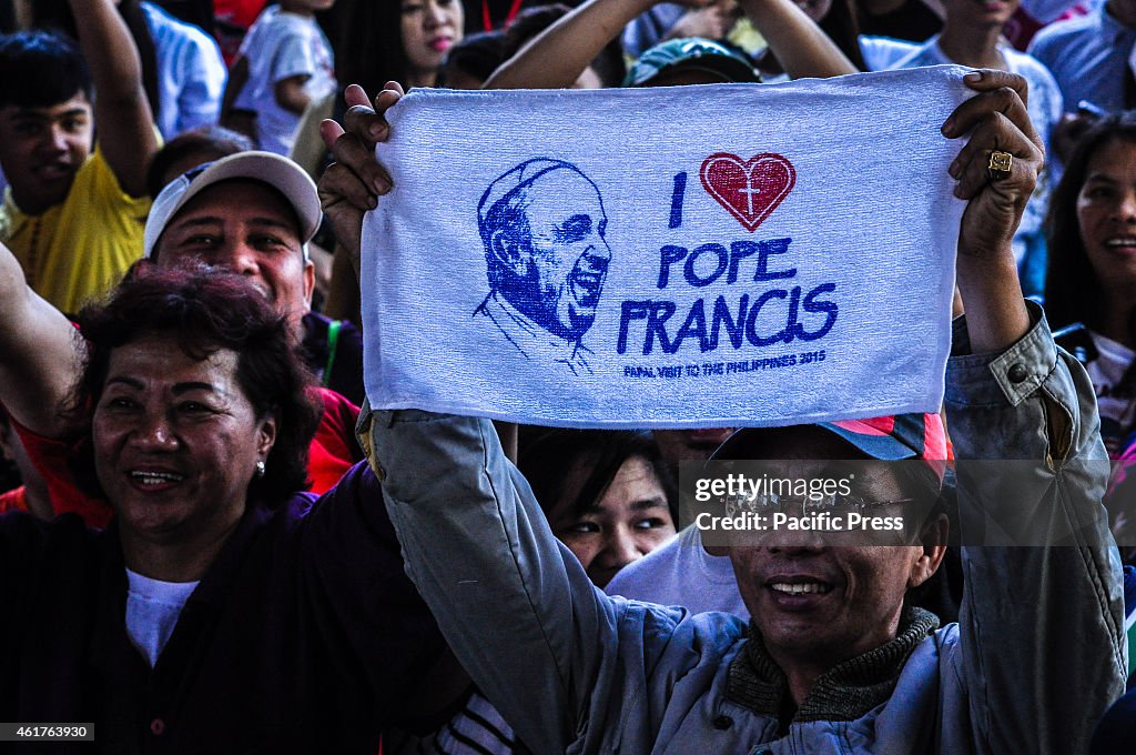 A man raise a towel with image of Pope Francis in Quirino...