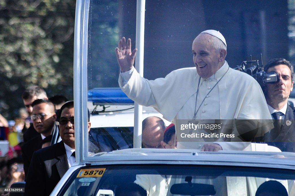 Pope Francis waves goodbye to spectators along Quirino...
