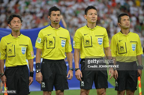 Referee Ryuji Sato from Japan stands with fourth official Muhammad Taqi of Singapore, and linesmen Toru Sagara and Toshiyuki Nagi from Japan, before...