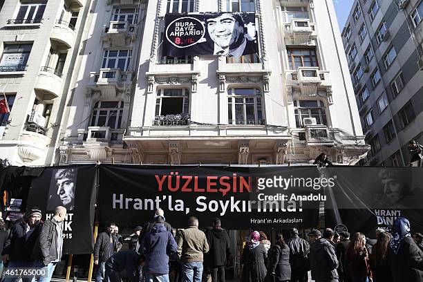 People gather outside the Agos newpaper building during a commemoration ceremony on the 8th death anniversary of Hrant Dink, former editor-in-chief...