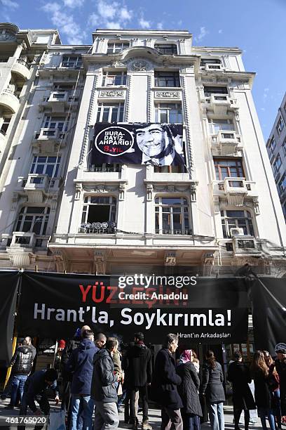 People gather outside the Agos newpaper building during a commemoration ceremony on the 8th death anniversary of Hrant Dink, former editor-in-chief...