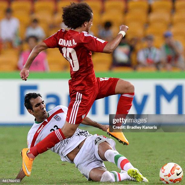 Mehrdad Pooladi of Iran tackles Omar Abdulrahman of the United Arab Emirates during the 2015 Asian Cup match between IR Iran and the UAE at Suncorp...