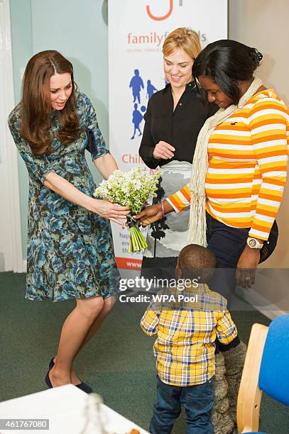 Catherine, Duchess of Cambridge meets 2-year-old Ryan and his mother Tracy Dixon who presented her with flowers as she attends a coffee morning at...