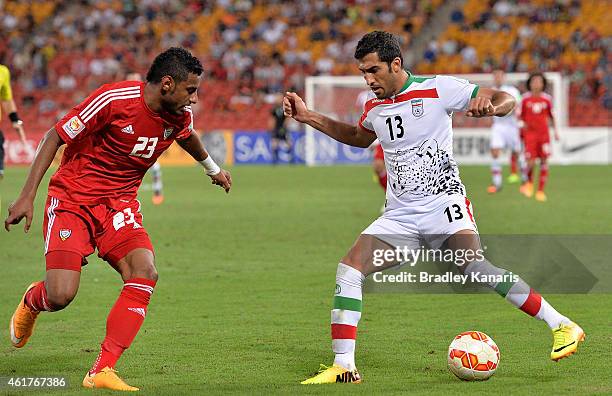 Vahid Amiri of Iran takes on the defence of Mohamed Ahmed of the United Arab Emirates during the 2015 Asian Cup match between IR Iran and the UAE at...